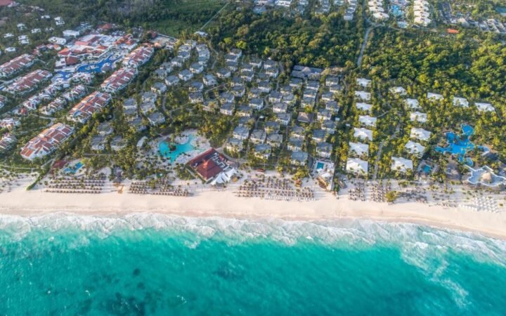 Beachfront swimming pool and palm trees at Grand Bavaro Princess Punta Cana