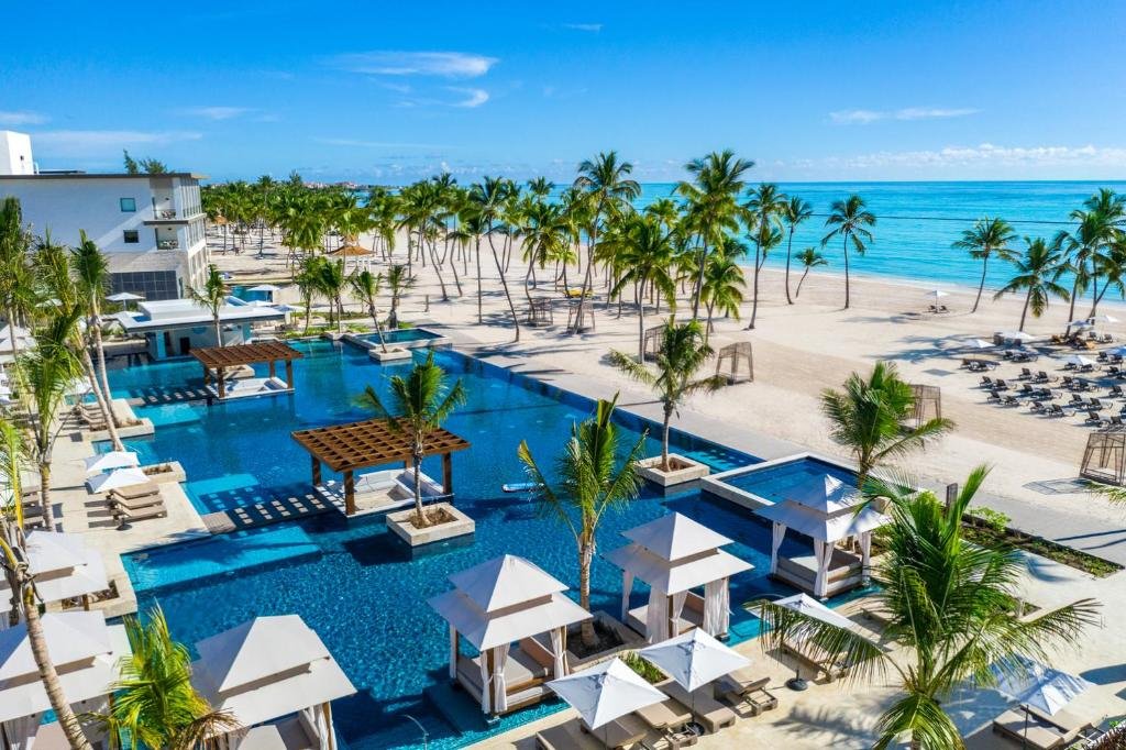 Beachfront lounge cabanas and palm trees at Hyatt Zilara Cap Cana