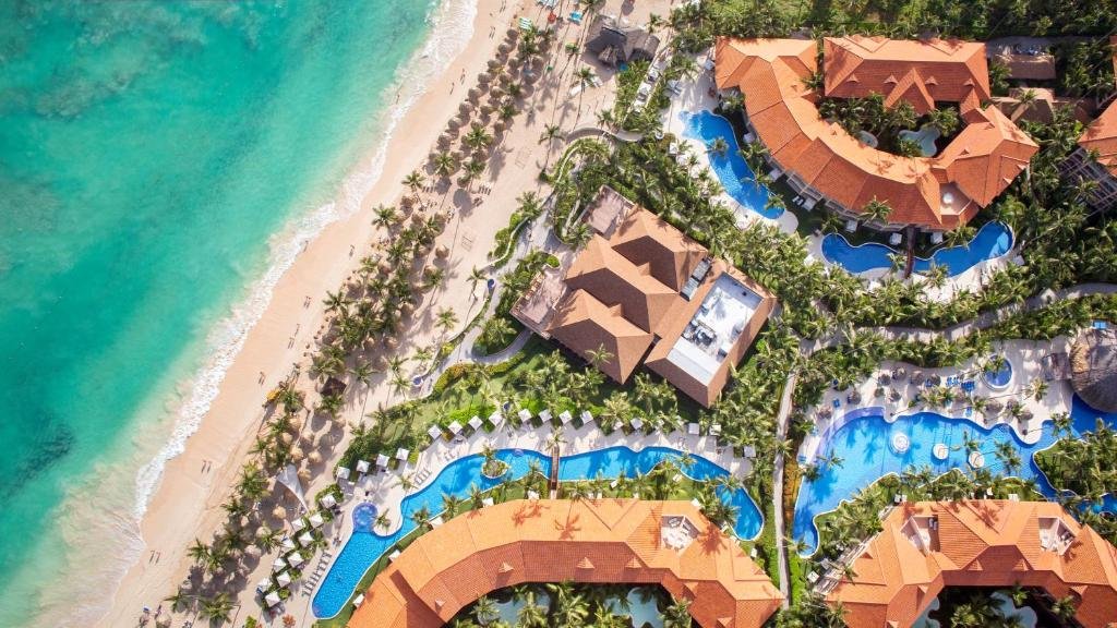 River-style swimming pool and palm gardens at Majestic Elegance Punta Cana