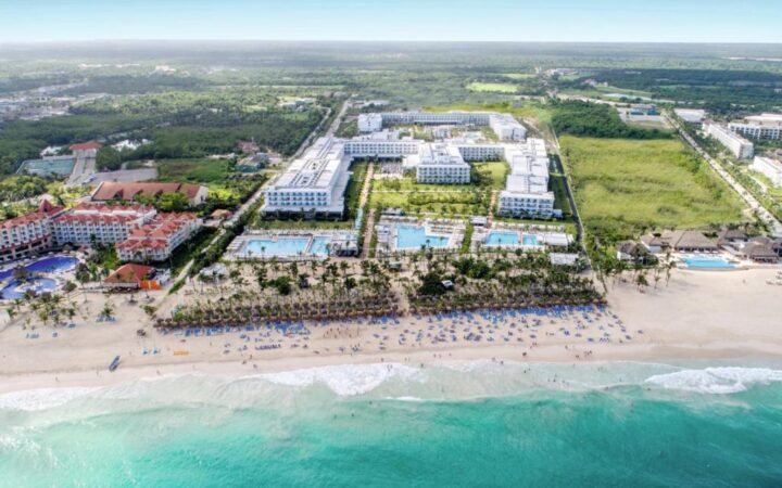 Beachfront infinity pools and palm trees at Hotel Riu Republica Adults Only