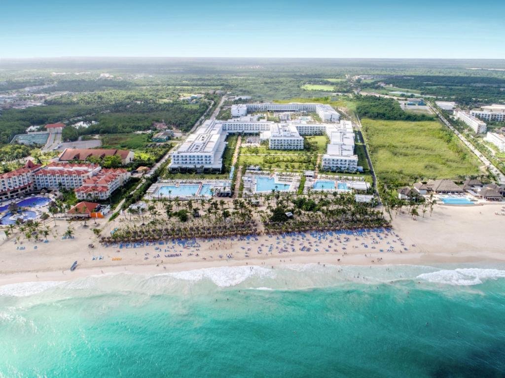 Beachfront infinity pools and palm trees at Hotel Riu Republica Adults Only
