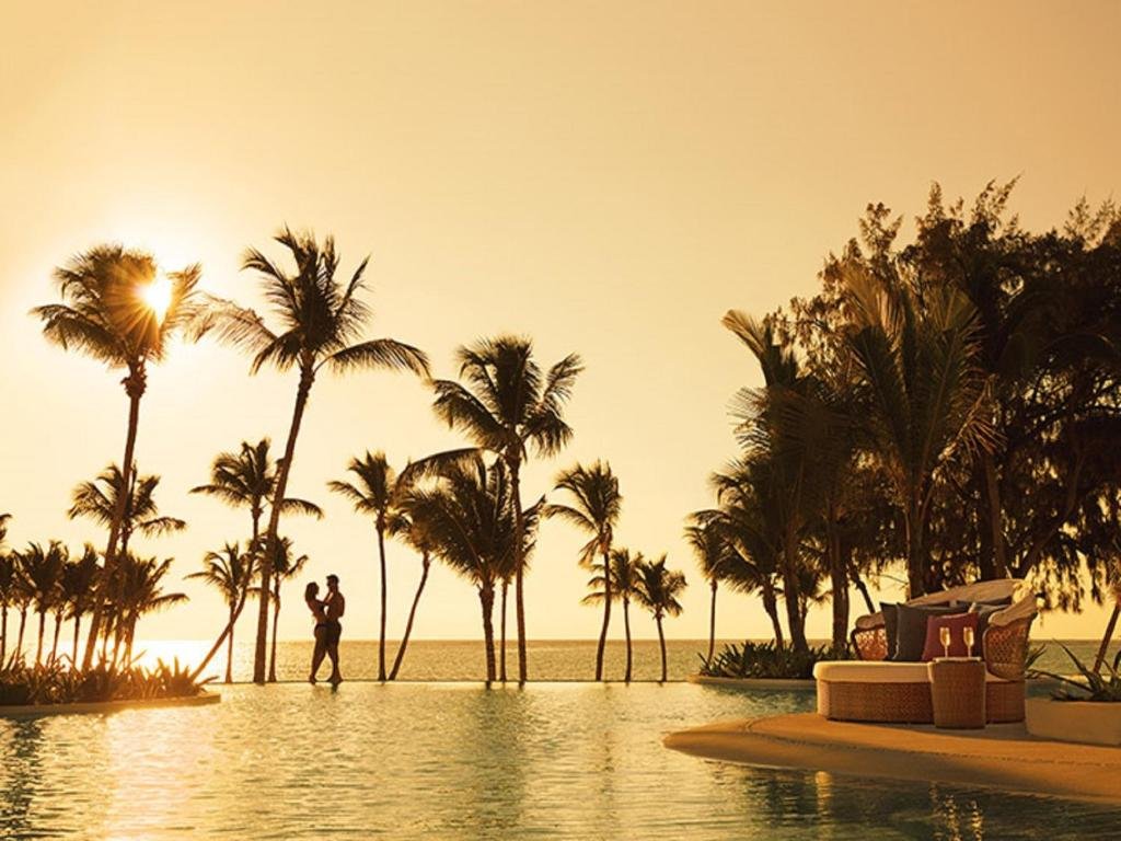 Lagoon pool and palm-fringed Juanillo Beach at Secrets Cap Cana Resort & Spa