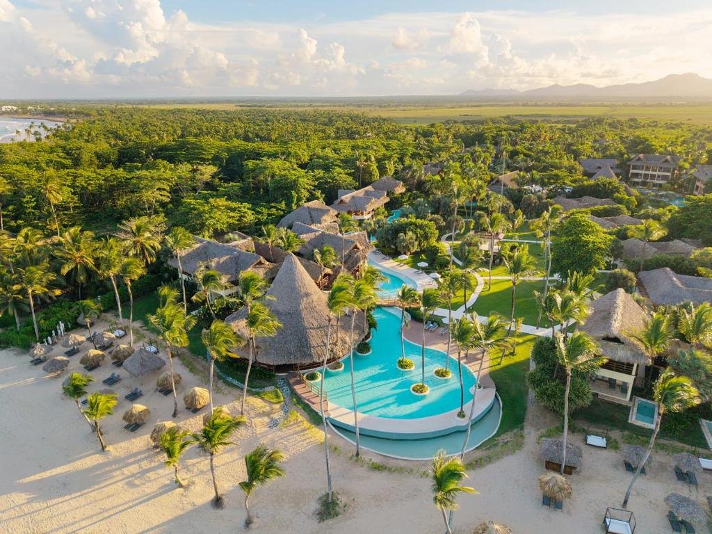 Serpentine infinity pool and thatched suites at Zoetry Agua Punta Cana